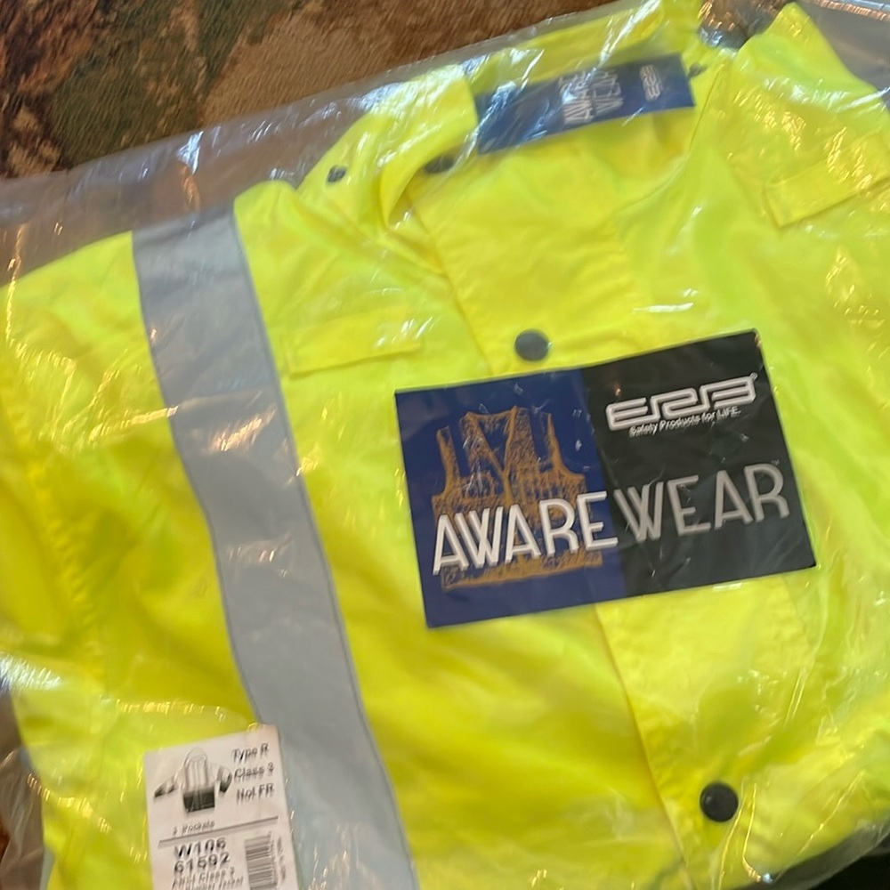 High visibility jacket. New in pkg. reflective lines.